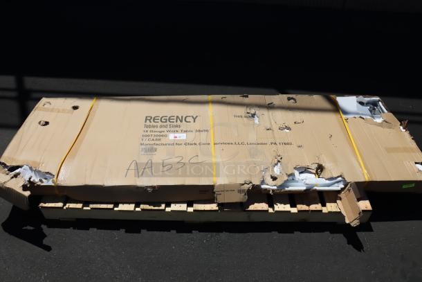 Regency 600T3096G 30" x 96" stainless steel work table in original damaged packaging; may have small defects.