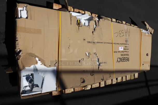 Regency 600T3096G stainless steel work table in damaged packaging, possible missing pieces, and signs of scratching and denting.