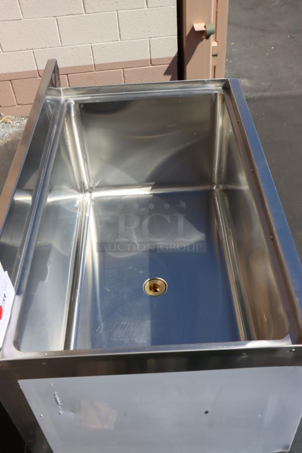 Regency 600IB1830 18"x30" underbar ice bin, unused, minor backsplash bend, missing back base. Stainless steel finish.