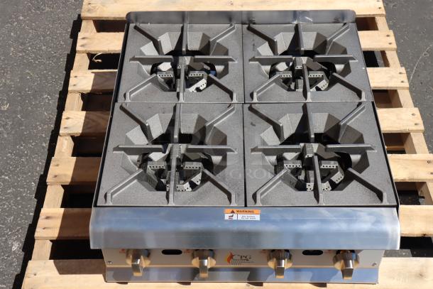 Cooking Performance Group R-CPG-24-NL 4 burner gas countertop range, 88,000 BTU, new, minor dents, on wooden pallet.