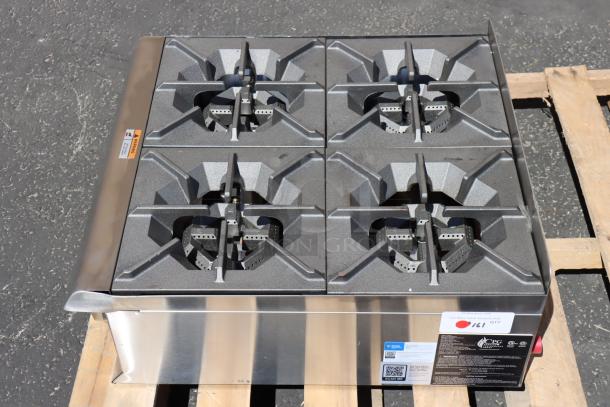 Brand new Cooking Performance Group R-CPG-24-NL 4 burner gas countertop range, 88,000 BTU, minor dents, tags visible.