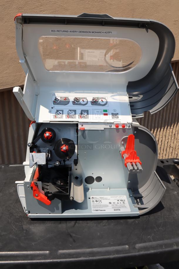 BRAND NEW Avery-Dennison ADTP1BA01NA barcode label printer, open view, serial number 19085204, with setup instructions inside.