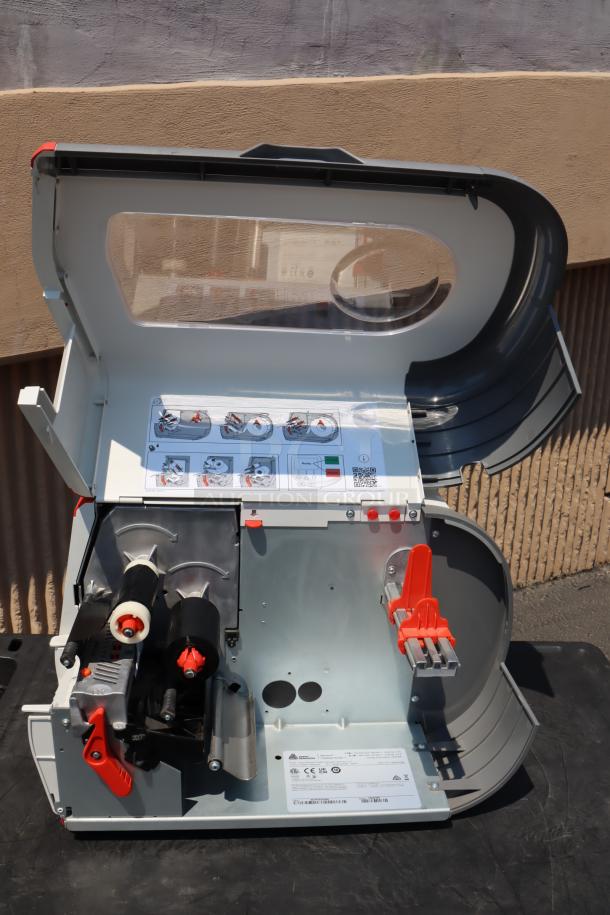 BRAND NEW Avery-Dennison ADTP1EF01NA Tabletop Barcode Label Printer, S/N: 22047929. Open case view showing internal components and instructions.