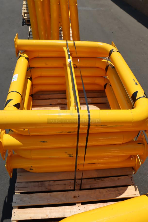 Yellow Vestil HPRO-48-42-4 steel rack guard, 48"x42"x4", with scuff marks, dents, and chipped paint, stacked on a pallet.