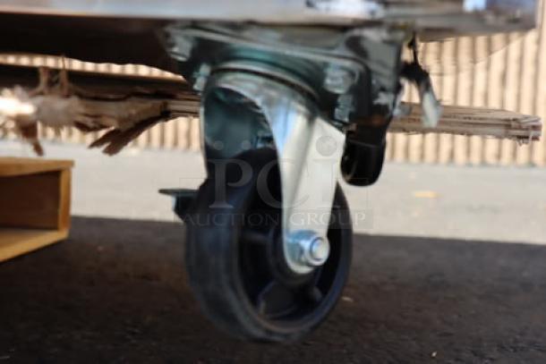 Bent caster on Avantco SS-UD-3R stainless steel undercounter refrigerator, never used, with scratches and dents.