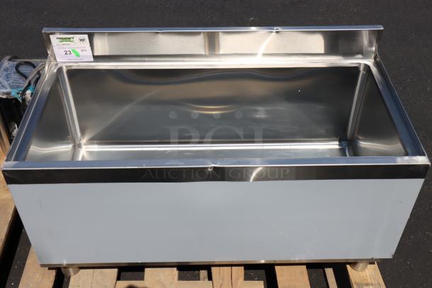 Regency 18"x36" stainless steel underbar ice bin, missing sliding lid, has small scratches and dents; galvanized legs.