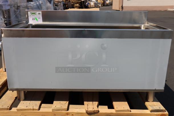 Regency 18"x36" stainless steel underbar ice bin on galvanized legs; missing lid, small scratches and dents, new condition.
