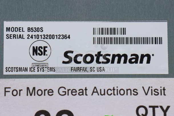 NSF-certified Scotsman B530S Ice Storage Bin label, serial 24101320012364, damaged ice bin door.