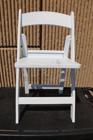 White resin folding chair by Lancaster Table & Seating, model 427FCRSLTWHT, with a slatted seat, new condition.