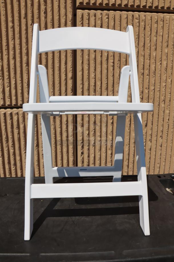 Lancaster Table & Seating white resin folding chair, slatted seat, new condition, model 427FCRSLTWHT.