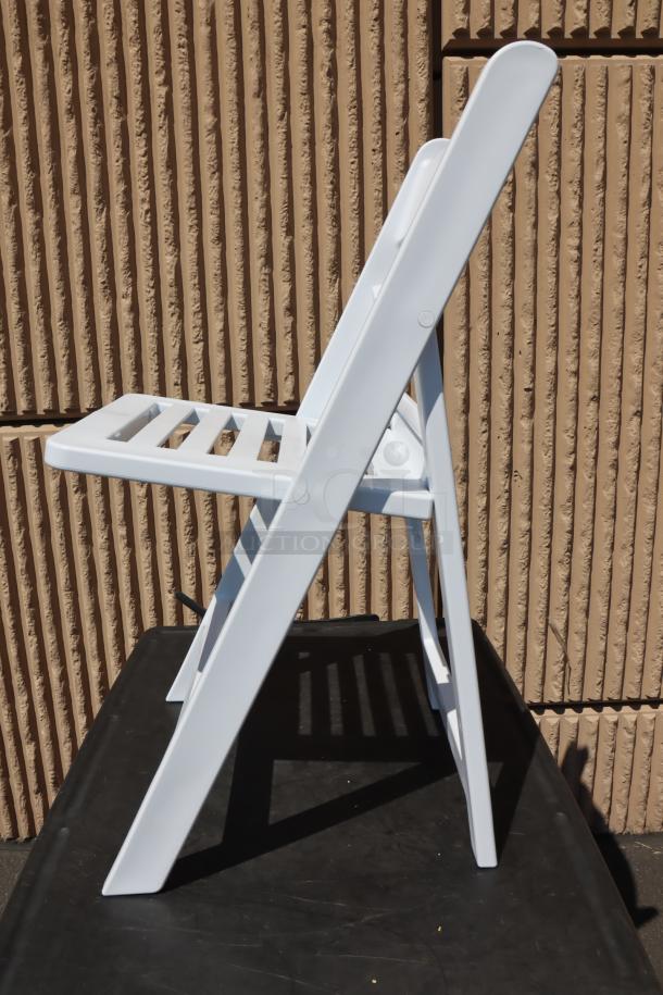 Lancaster Table & Seating white resin folding chair with slatted seat, model 427FCRSLTWHT, new condition, side view.