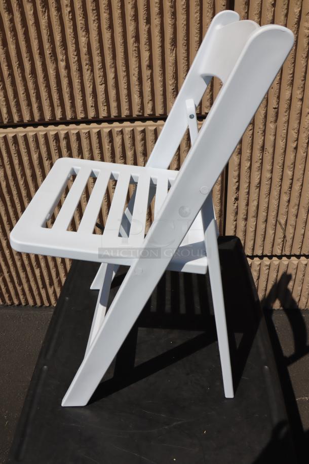 NEW Lancaster Table & Seating white resin folding chair, model 427FCRSLTWHT, slatted seat, pristine condition.