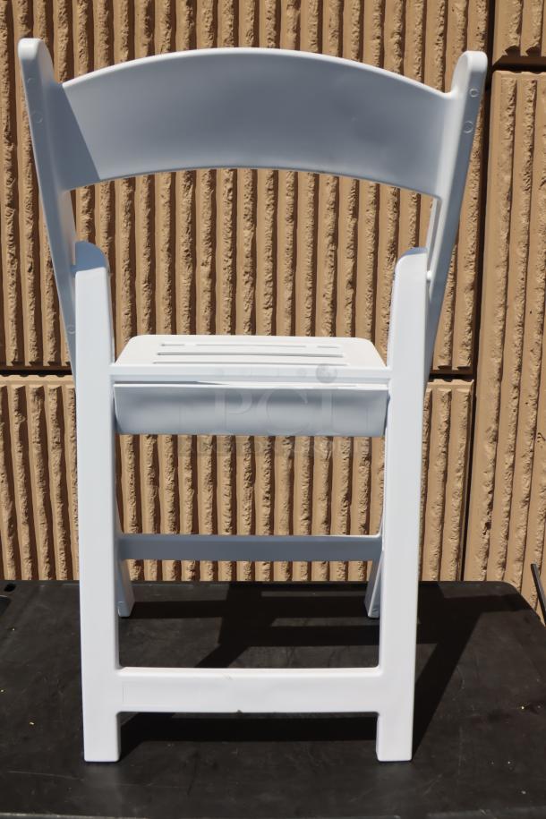 Lancaster Table & Seating white resin folding chair with slatted seat, model 427FCRSLTWHT. New condition.