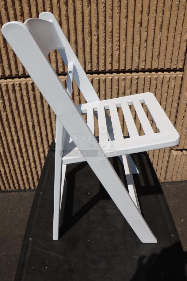 Lancaster Table & Seating white resin folding chair, slatted seat, model 427FCRSLTWHT, new condition, box torn, exposed.