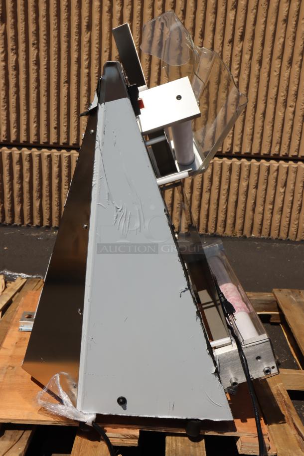 Alt text: Estella EDS18D 18" countertop dough sheeter, scratched and dented, viewed from the side on a pallet.