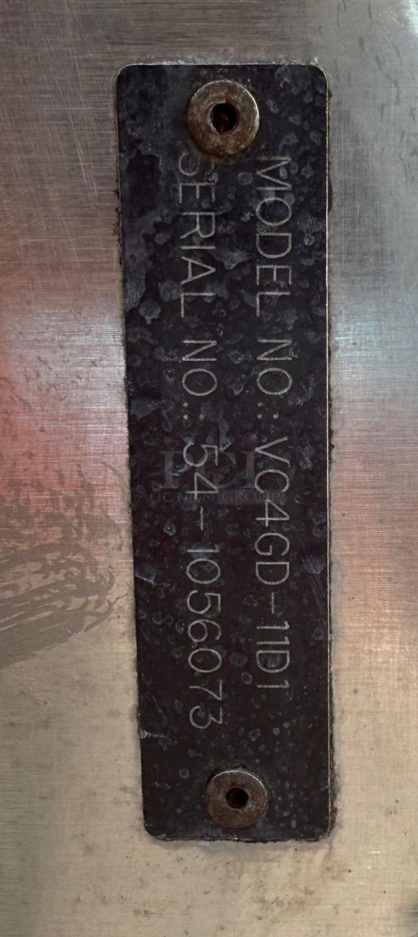 Metal label showing model number VC4GD-11D1 and serial number 541056073 on a Vulcan gas convection oven.