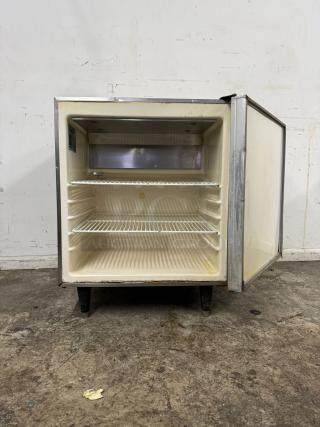 Silver King SKTTR7 Undercounter Refrigerator, open door. Features wire shelves, used condition, visible wear.