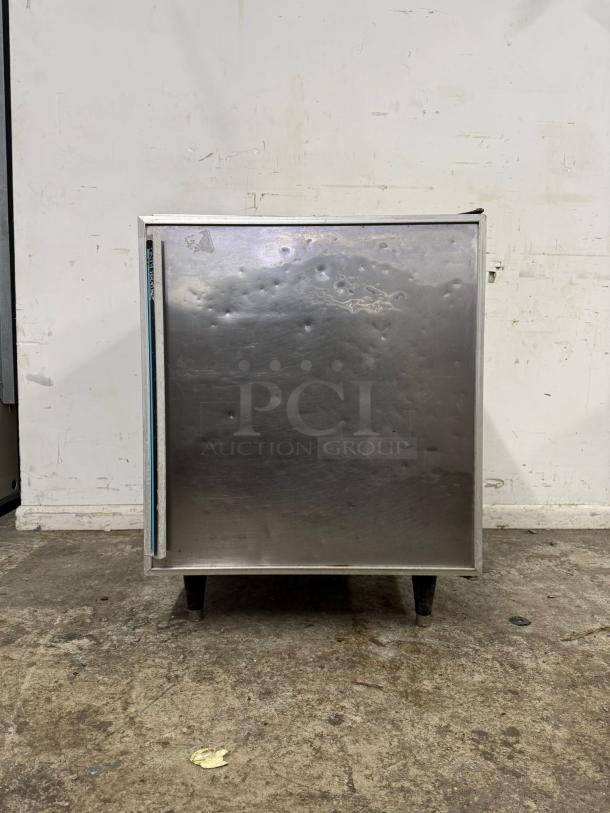Silver King SKTTR7 Undercounter Refrigerator, dented stainless steel door, visible wear, sturdy black legs.