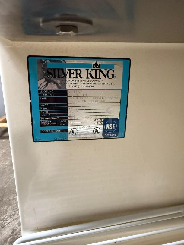 Silver King SKTTR7 undercounter refrigerator with model label, featuring specs and NSF certification. Good condition.