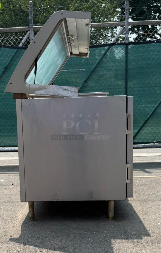 Heatcraft Refrigerator Unit RAMK23AG, stainless steel exterior, side view, open top, showing moderate wear, industrial setting.