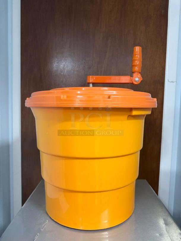 Dynamic Manual Salad Spinner, orange plastic, sturdy handle, dries lettuce efficiently, excellent condition.