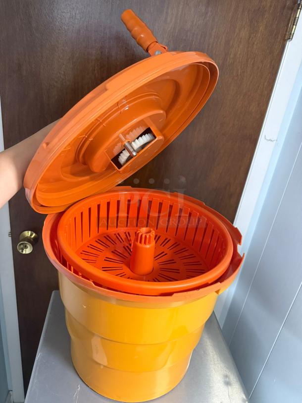 Dynamic manual salad spinner, bright orange, with handle and spinning mechanism. Excellent condition, ideal for drying lettuce.