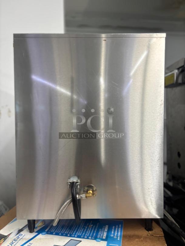 Fetco Coffee Brewer E32015, stainless steel, features a sleek design, visible water line, in used condition.
