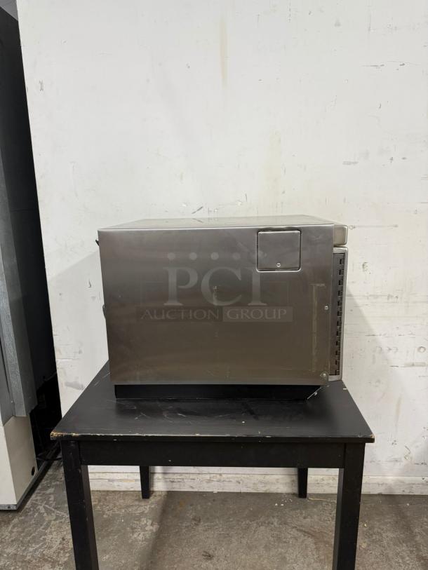 MENUMASTER RC17S2 commercial microwave, 19", 1700W, stainless steel, good condition, on black table.