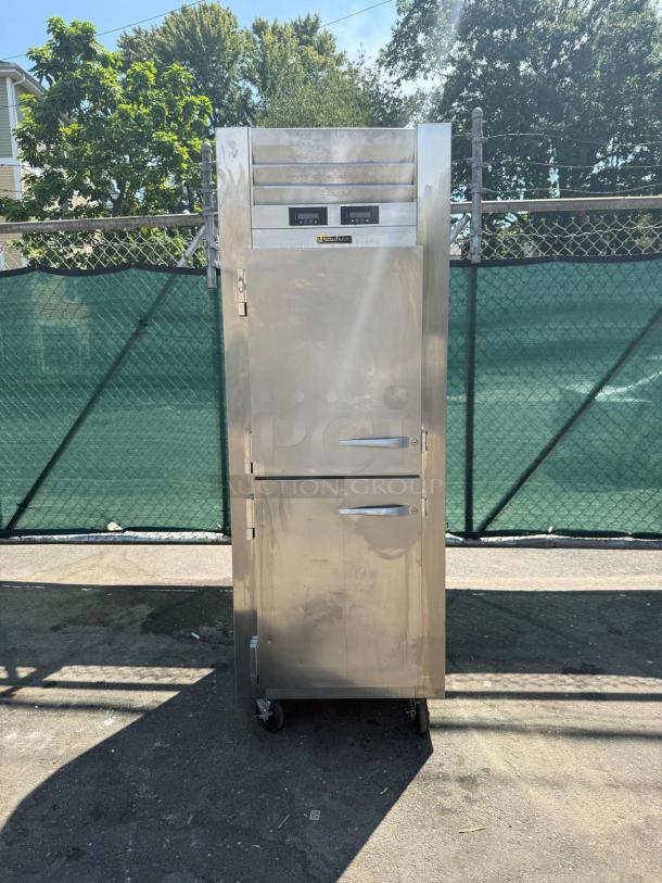 Traulsen RDT132WUT-HHS 29" dual temp reach-in refrigerator freezer, stainless steel, on wheels, well-maintained condition.