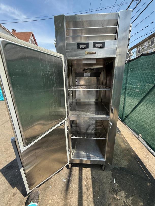 Traulsen RDT132WUT-HHS 29" dual temp refrigerator freezer, stainless steel, reach-in, two doors open, good condition.