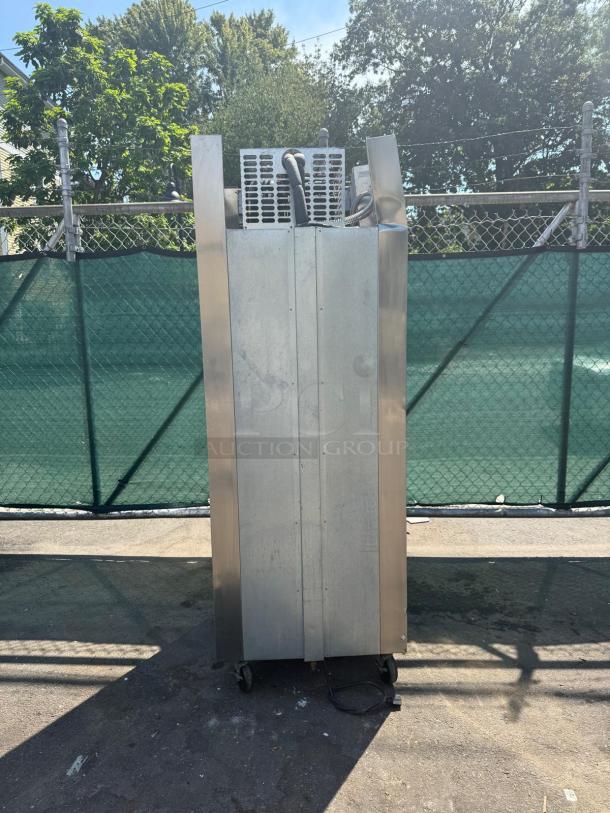 TRAULSEN RDT132WUT-HHS 29" dual temp refrigerator freezer, stainless steel, upright, visible compressor, on casters.