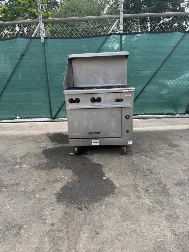 Vulcan 36S-6BN 6 burner natural gas range with standard oven, 215,000 BTU, labeled, stainless steel, outdoors, on wheels.
