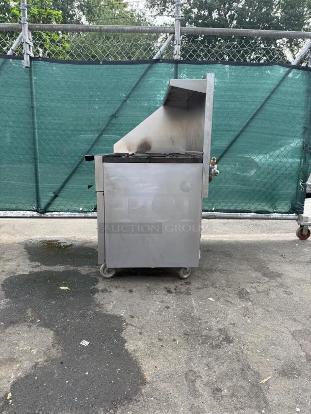 Vulcan 36S-6BN 6-burner gas range with oven, 215,000 BTU, stainless steel, on casters, used condition.