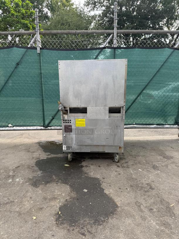 Vulcan 36S-6BN 6 Burner Range, natural gas, 36", 215,000 BTU, standard oven base, on wheels, outdoor setting, rear view.