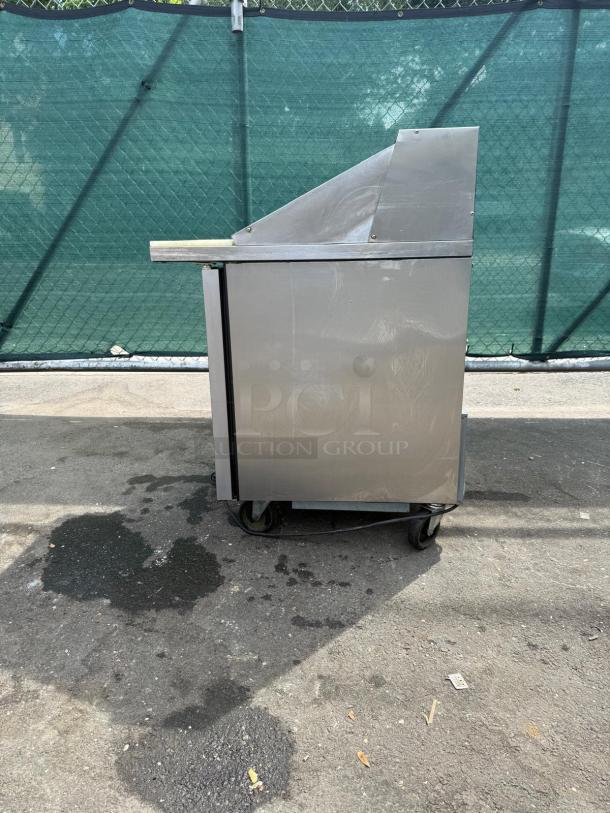 TRUE TSSU-27-12M-C-HC refrigerated sandwich prep table, right-hinged door, fair condition, shown from side view.