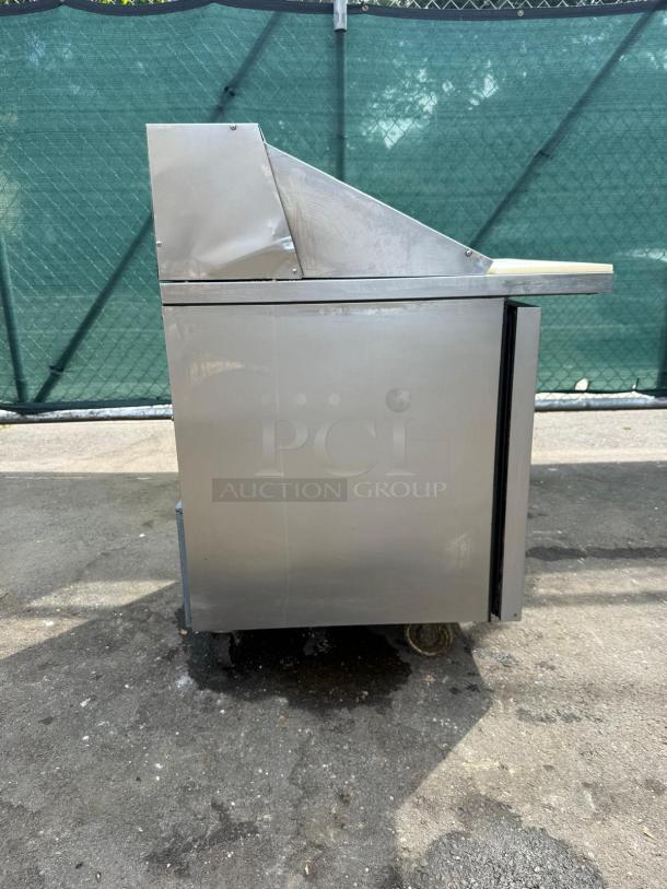 TRUE TSSU-27-12M-C-HC prep table, stainless steel, right-hinged door, fits 4" pans, slight wear on exterior.