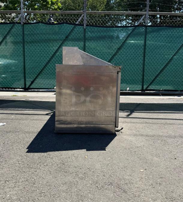 Stainless steel 3-door refrigerated sandwich prep table, Delfield Model 4472M-30M-A1, used condition, side view.