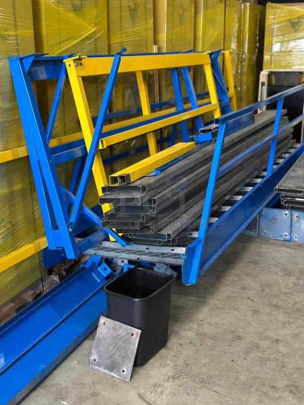 Disassembled used warehouse mezzanine, featuring blue and yellow metal supports, ready for storage space setup.
