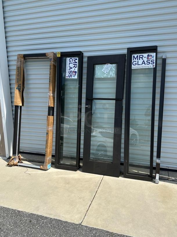 Mr. Glass doors and windows, various sizes, black frames, new condition, branded tags visible.