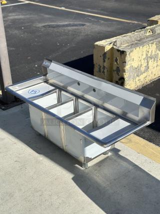 Steelton 54" stainless steel 3-compartment sink, model 522CS31014LR. Features two drainboards, 10"x14"x12" bowls, new condition.