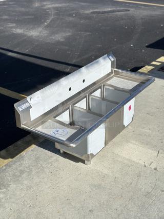 Steelton 54" 18-gauge stainless steel sink, model 522CS31014LR, with 3 compartments and 2 drainboards. New, scratch, and dent condition.