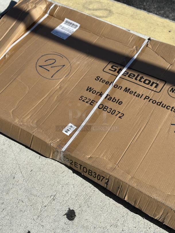 Cardboard box labeled "Steelton Work Table 522ETOB3072," showing slight damage. Contains new 30" x 72" 18-gauge 430 stainless steel table.