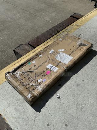 Steelton 20 Pan End Load Rack, model 109RACKECON, in original packaging. Box shows scratches and dents. Unassembled.