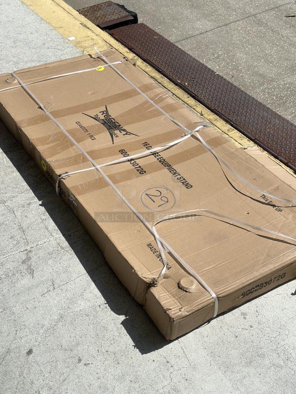 Brand new Regency 30"x72" stainless steel equipment stand, model 600ES3072G. Packaging shows scratches and dents.