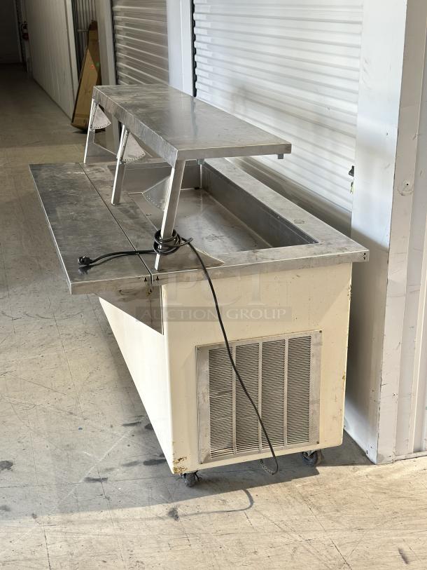 Used Shelleyglas by Delfield serving station with undershelf. Features stainless steel finish, visible wear, and ventilation panel.