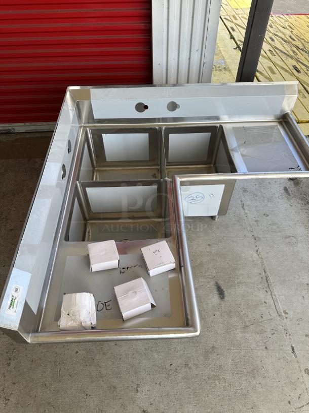 Regency 57" stainless steel corner sink, three compartments, 16-gauge, with two drainboards. Model 600S31620C, scratch and dent condition.