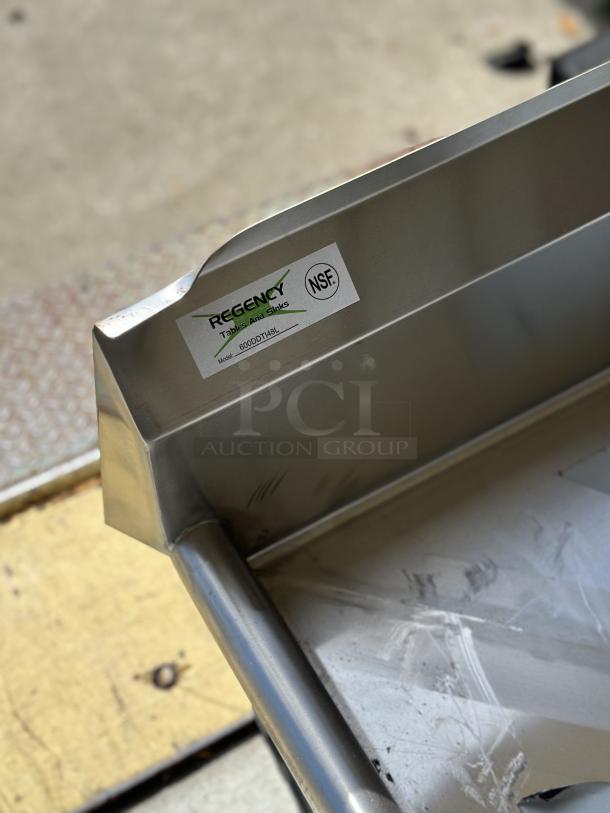 Regency 4' stainless steel L-shape dishtable, model 600DDTI48L. New with minor scratches, NSF certified label visible.