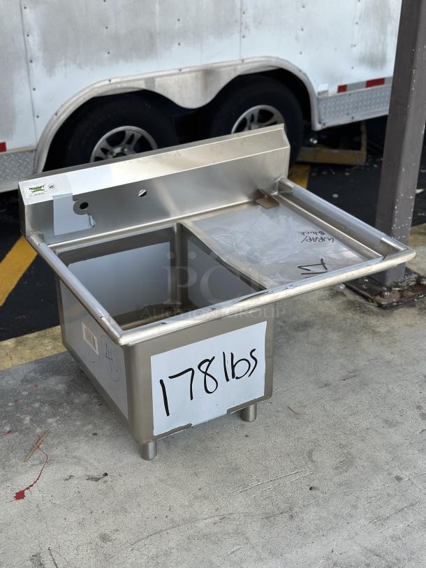 Brand new Regency sink component with right drain board, model 600S1182418R, marked 178 lbs, visible scratch and dent.