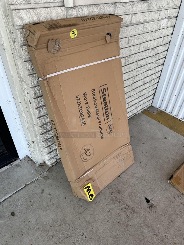 Steelton 24" x 48" 18-gauge 430 stainless steel work table in original packaging. Box shows wear. Model 55ETOB2448.