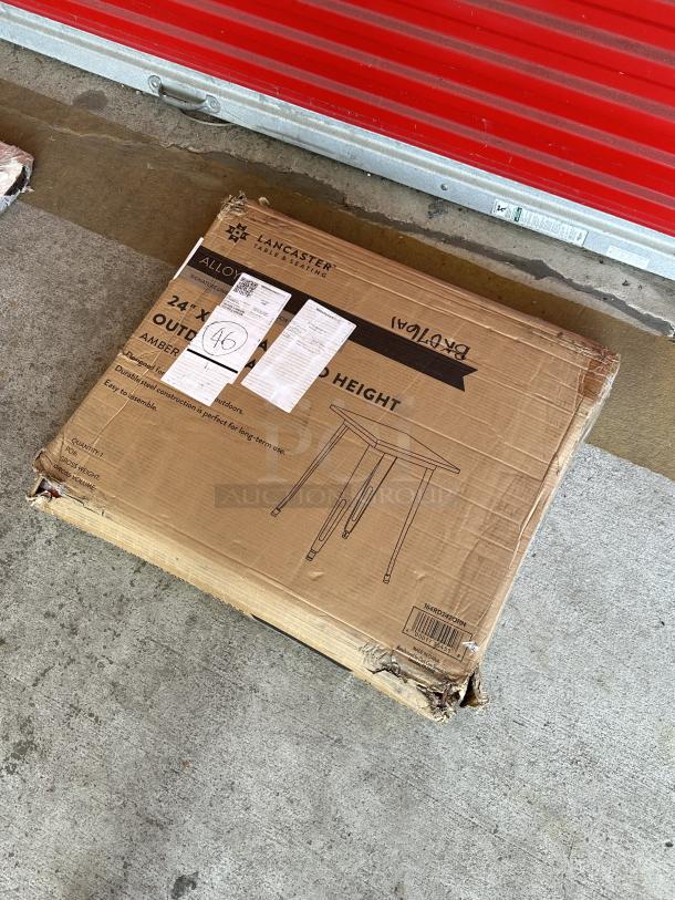 Brand new Lancaster Table & Seating 24"x24" Amber Orange outdoor table, model 164RD242ORN, in box, scratched/dented.